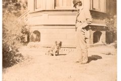 Man in a bowler hat with a dog at the Flavel House