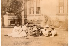 Relaxing on the Flavel House lawan with their tennis rackets