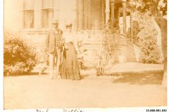 Nellie and unknown man in yard of the Flavel House