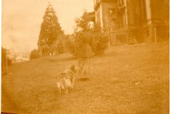 Women and her dog on the north side of the Flavel House lawn