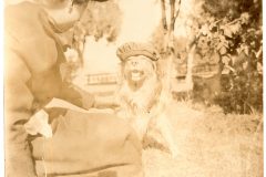 Nellie Flavel and her dog on the Flavel House lawn