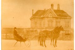 Horse and sleigh with snow on the ground, with the Flavel House in the background Horse and sleigh with snow on the ground, with the Flavel House in the background