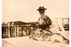 Woman and her dog sitting on dock. Woman and her dog sitting on dock.