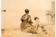Woman and her dog sitting on a dock Woman and her dog sitting on a dock