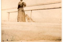 a woman on a doc with her dog. a woman on a doc with her dog.
