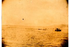 River view of a motorized boat towing two or three other boats. River view of a motorized boat towing two or three other boats.