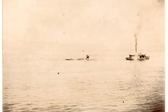 River view of a motorized boat towing two or three other boats. River view of a motorized boat towing two or three other boats.