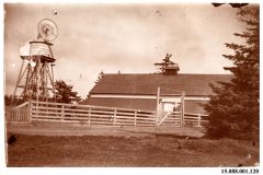 Barn with fence and water tower with wind mill. Barn with fence and water tower with wind mill.